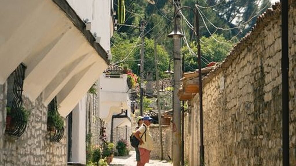 Backpacker on a cobblestone street in Berat, Albania