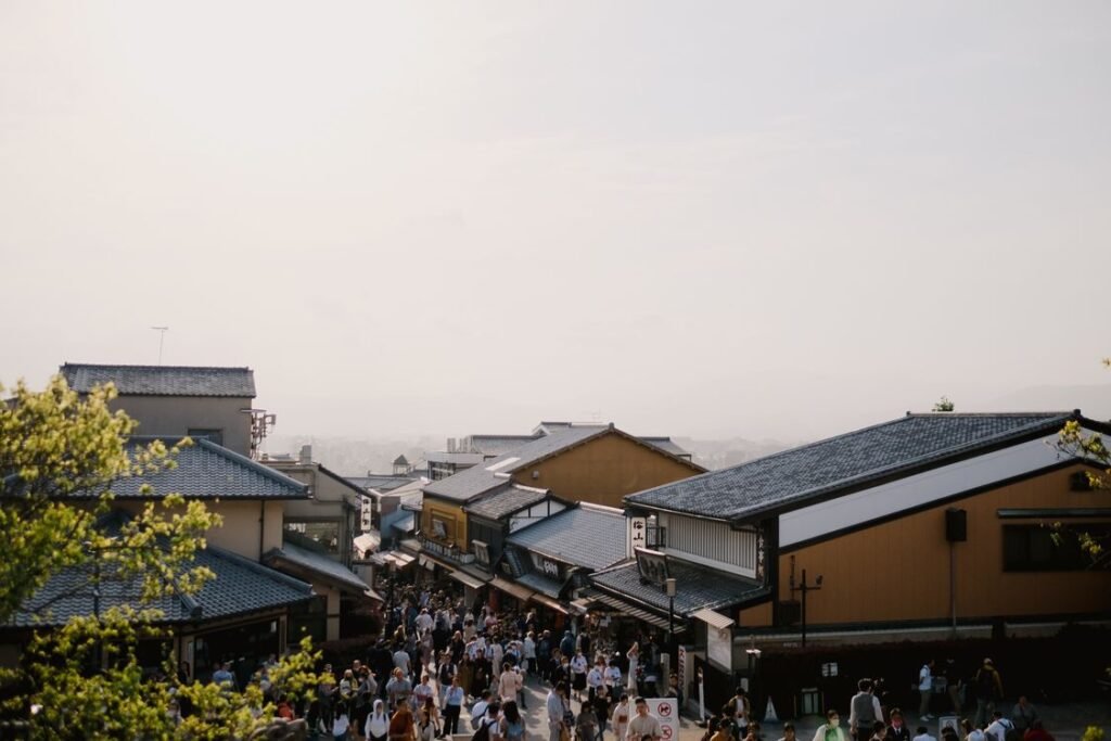 Travellers walking a crowded old-town street in Kyoto, one of the cheapest places to visit 2026